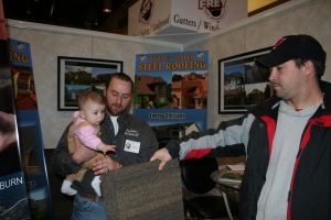Mark Frey of Frey Construction shows off a sample of our Gerard Stone Coated Steel Roofing.